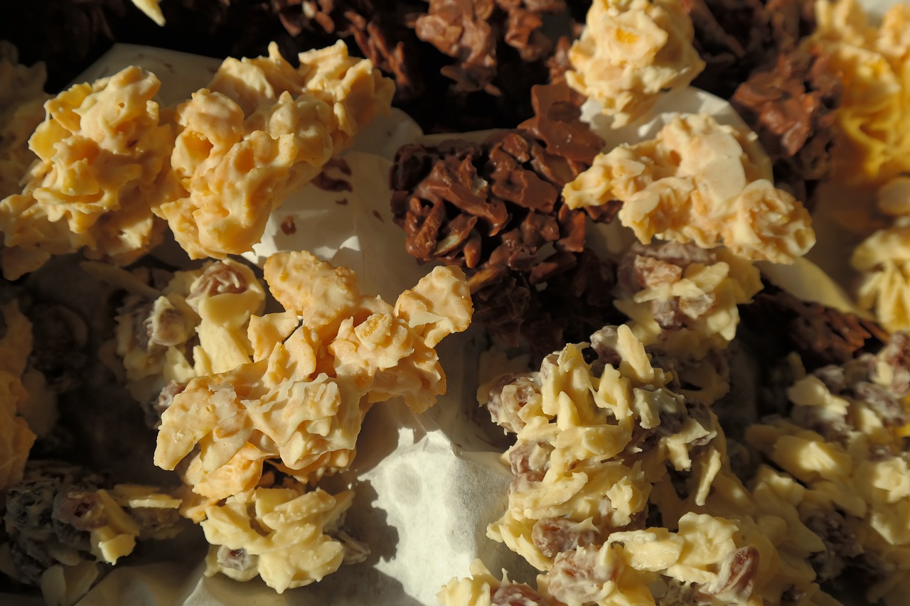 a bowl of cereal sitting on top of a table, a macro photograph, by Lee Loughridge, rococo, chocolate. intricate background, brittle. highly detailed, mac and cheese, dragon eggs