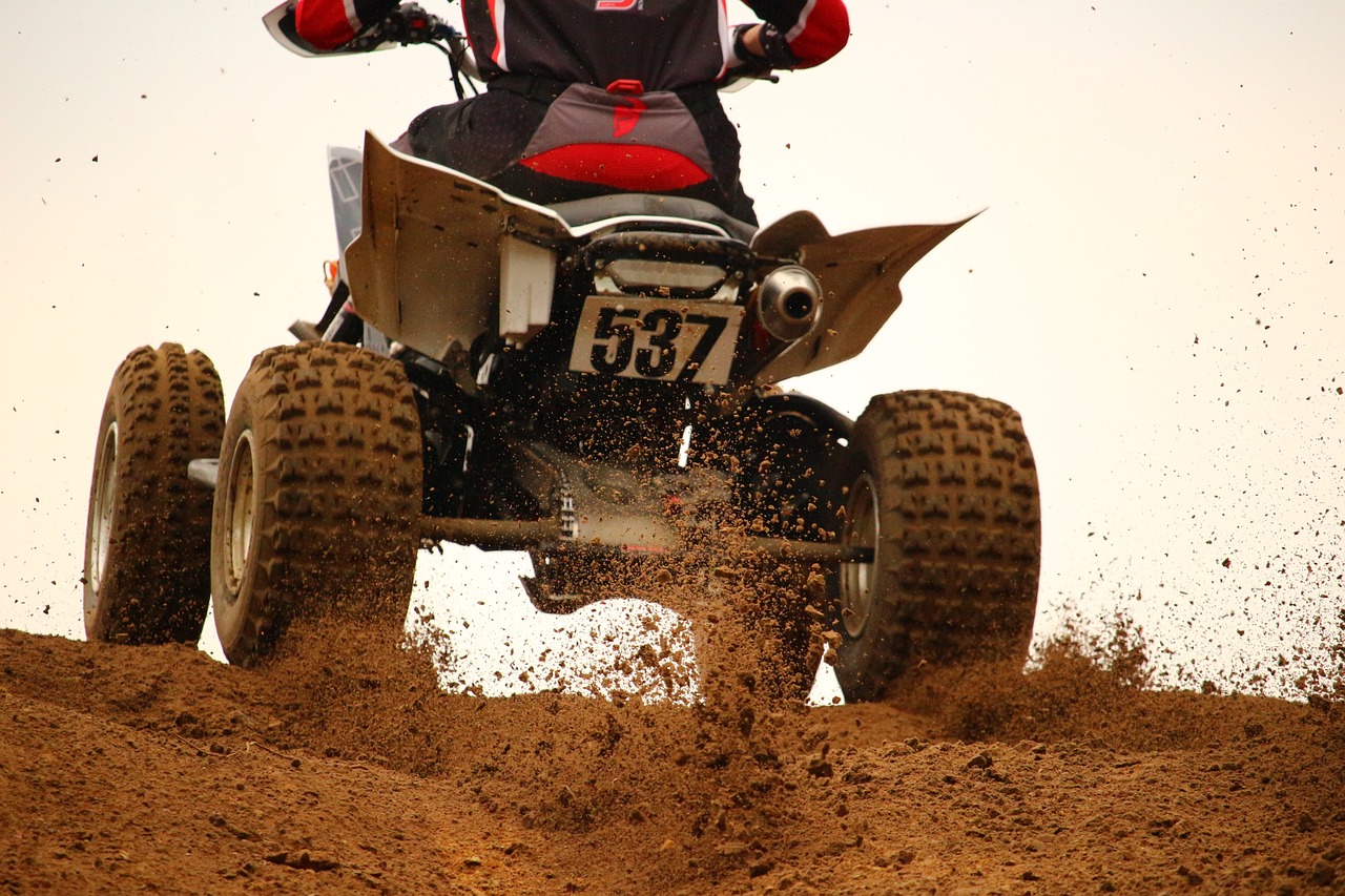 a man riding on the back of a dirt bike, a photo, shutterstock, all terrain vehicle race, detailed zoom photo, stock photo, albuquerque