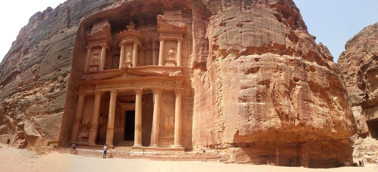 a couple of people that are standing in front of a building, a picture, inspired by Antonín Chittussi, in a large desert cave, classical architecture, listing image, jordan