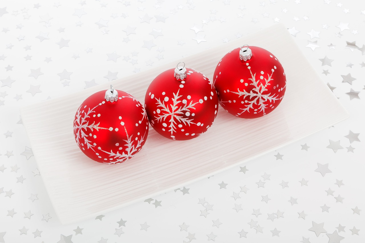 three red christmas ornaments on a white plate, a photo, miniature product photo, high detail product photo, bright stars, 3 4 5 3 1