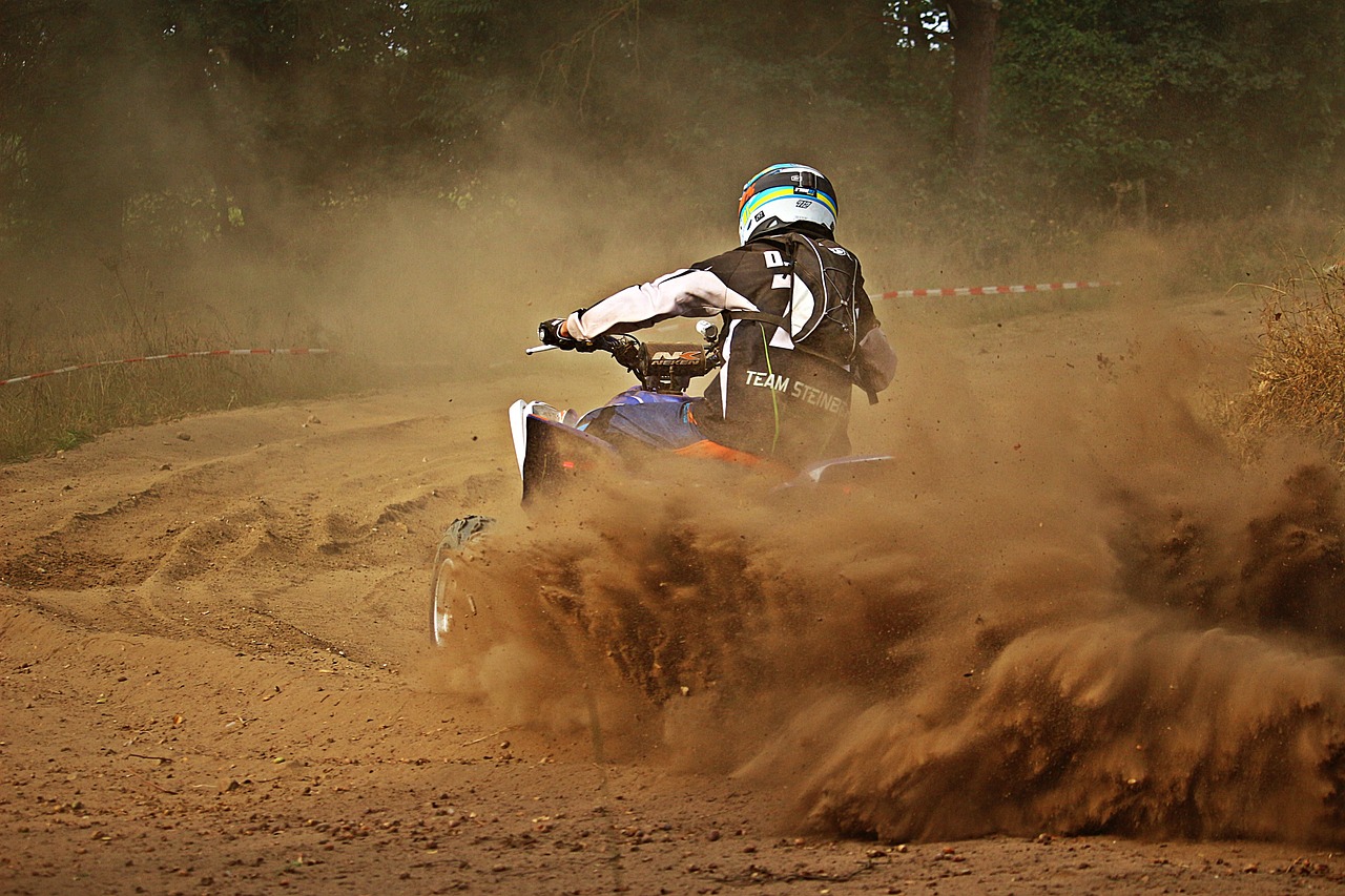 a person riding a dirt bike on a dirt road, a picture, by Thomas Häfner, flickr, sand particles, all terrain vehicle race, curves!!, in an arena pit