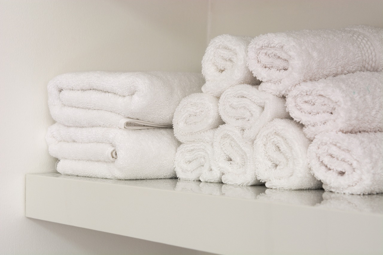 a shelf filled with lots of white towels, by John Murdoch, closeup photo, professional product photo, hyper-detail, close-up product photo
