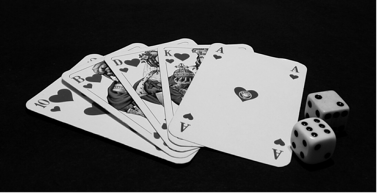 a black and white photo of playing cards and dice, a black and white photo, pexels, process art, queen of hearts, with a black background, computer wallpaper, hearthstone card game