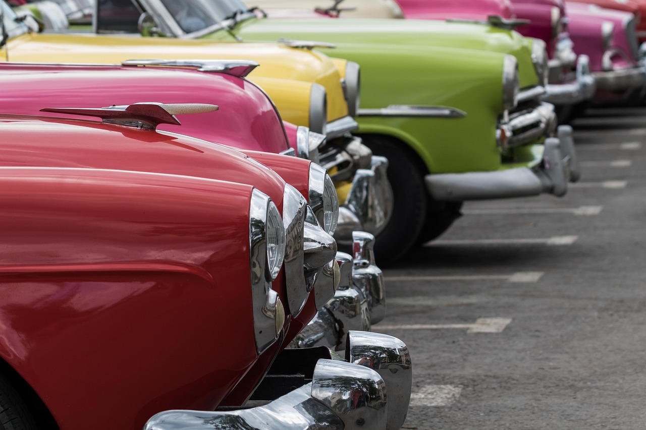 a row of old cars parked next to each other, a portrait, pexels, pop art, colors of jamaica, zoomed in, touring, perfect light