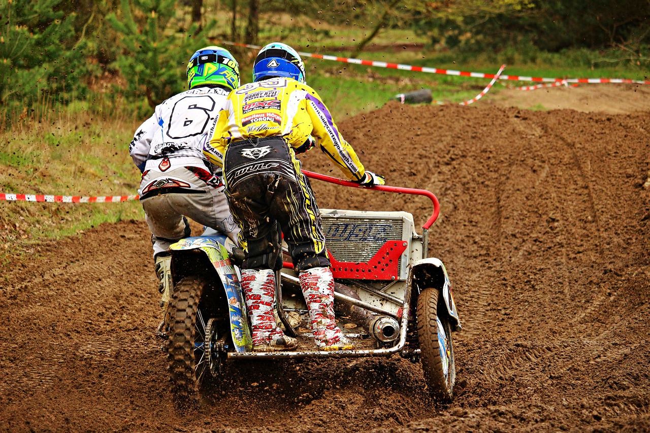 a couple of people riding on the back of a dirt bike, a photo, by Cornelisz Hendriksz Vroom, flickr, all terrain vehicle race, are-bure-boke!!!!!!!!, buggy, action photo