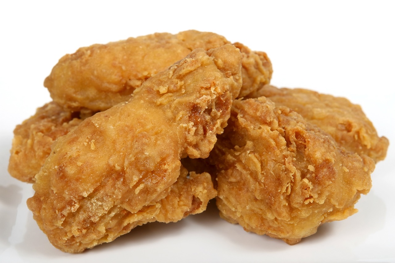 a pile of fried chicken sitting on top of a white plate, inspired by Chippy, pixabay, sōsaku hanga, 3/4 view from below, istock, four wings, hd —h 1024