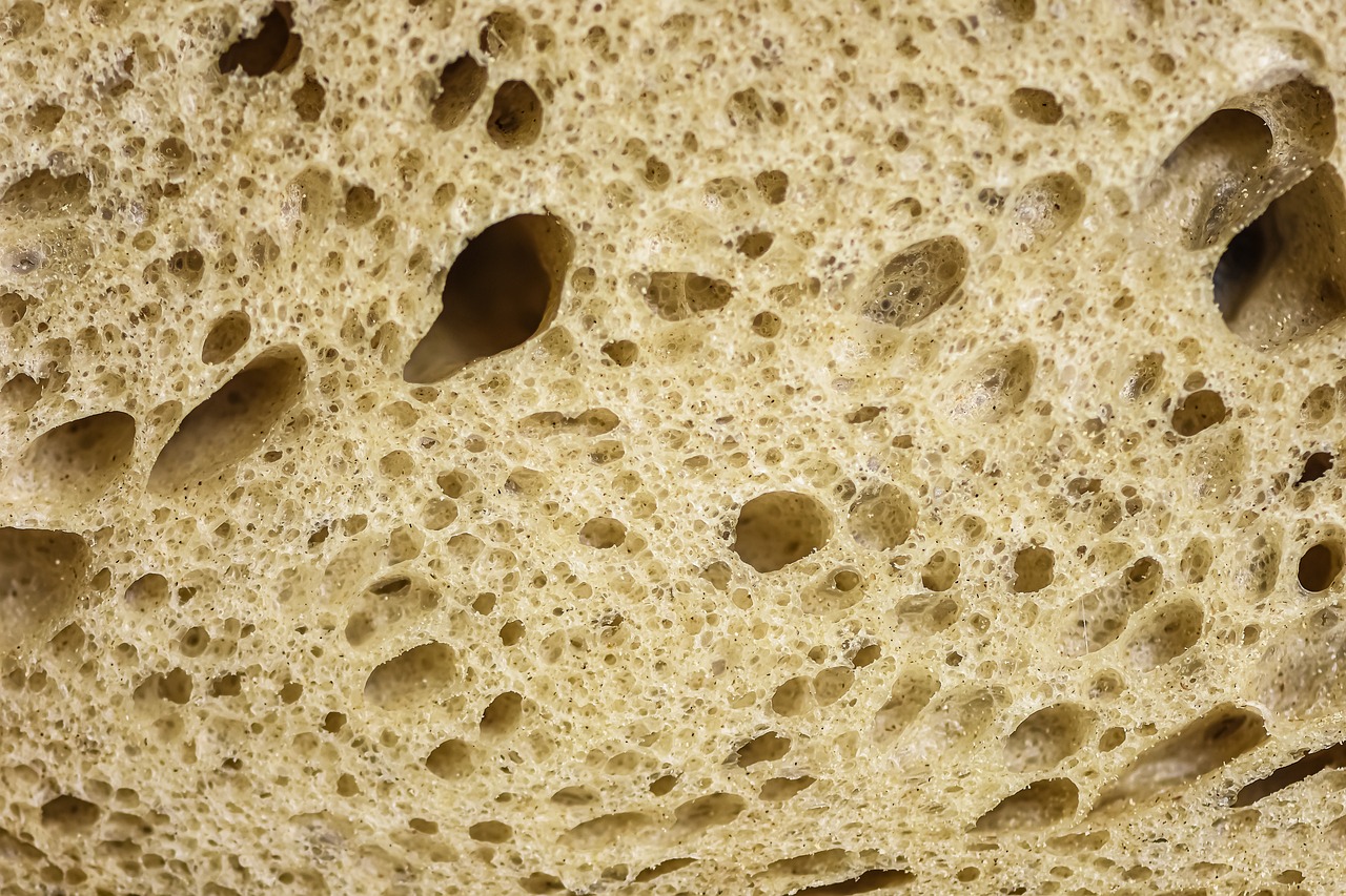 a close up of a piece of bread with holes in it, a macro photograph, flickr, limestone, highly detailed product photo, loaves, close-up product photo
