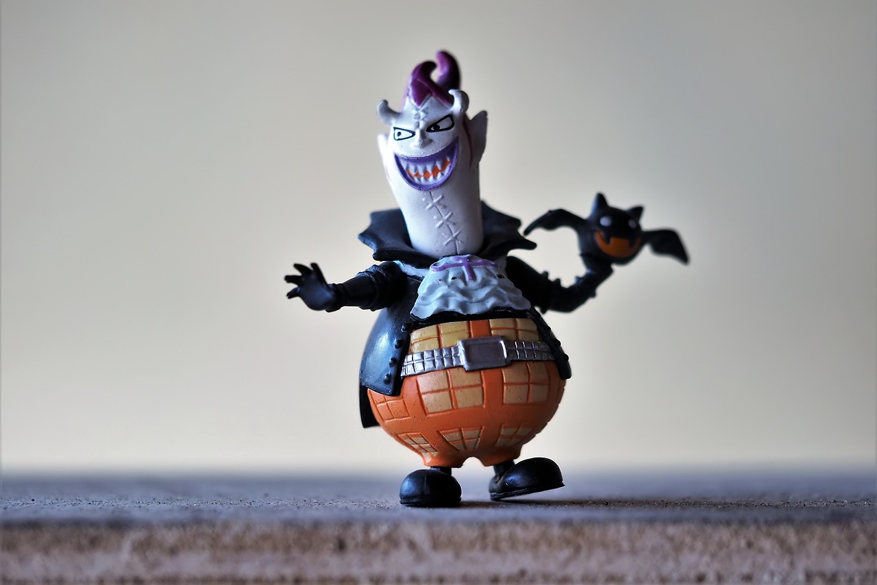 a close up of a toy on a table, a picture, inspired by Tex Avery, flickr, evil standing smiling pose, in a halloween style, the batman who laughs, he has a big egg