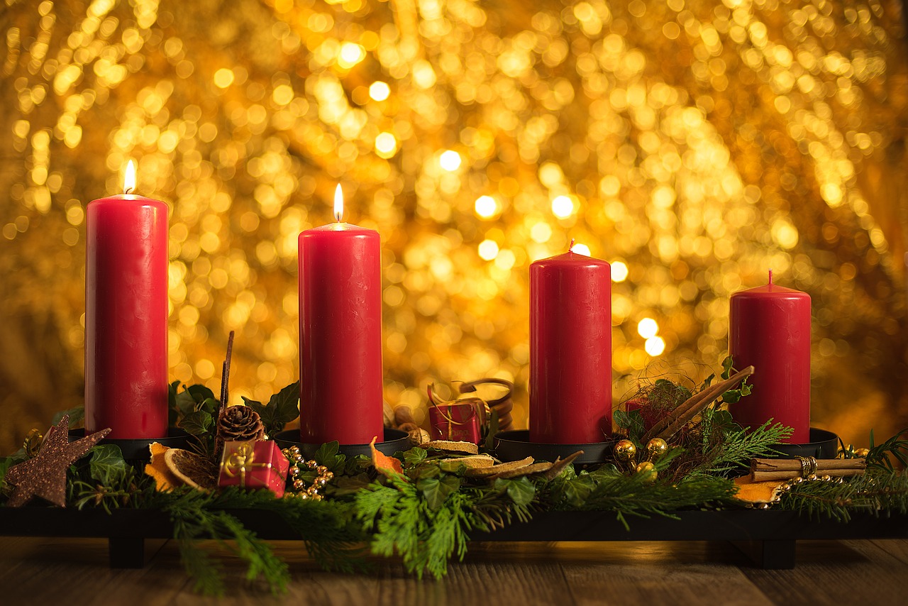 a group of red candles sitting on top of a wooden table, shutterstock, golden details!, christmas, relaxed. gold background, high quality product image”