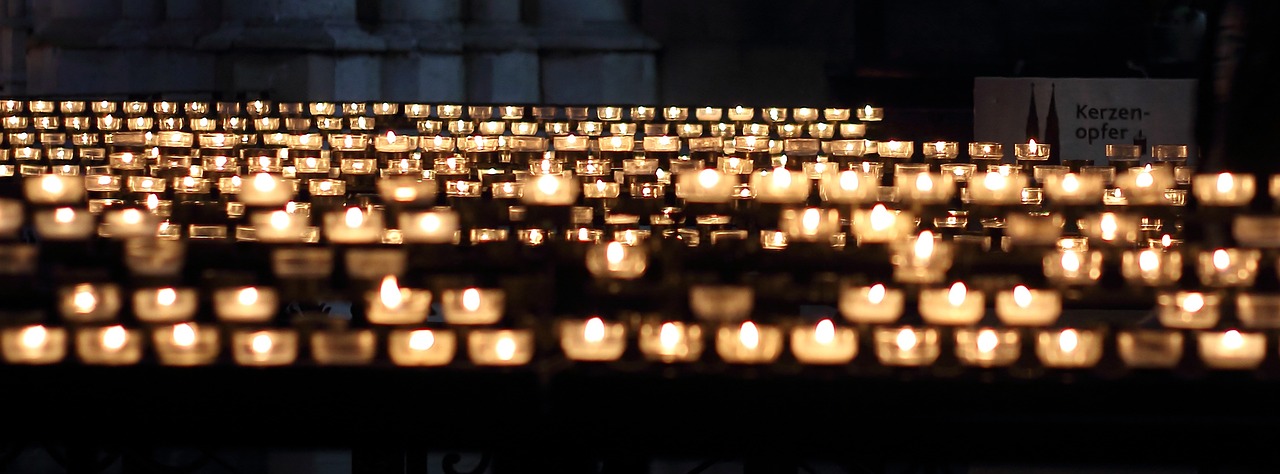 a group of lit candles sitting on top of a table, chartres cathedral, reduce duplication interference, hundreds of them, from the distance