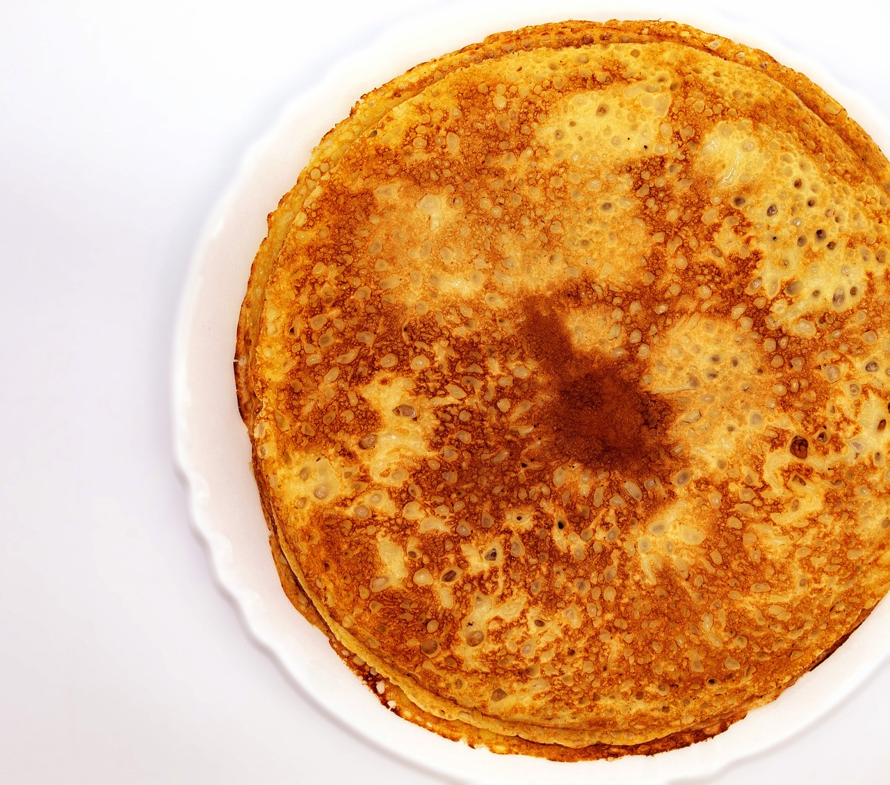 a stack of pancakes sitting on top of a white plate, a stipple, by Eva Gonzalès, flickr, hurufiyya, wide overhead shot, ethiopian, highly detailed product photo, istock