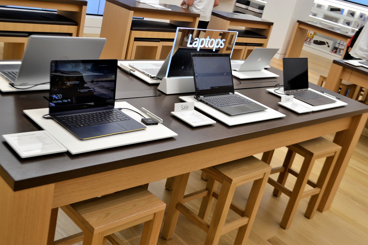a group of laptops sitting on top of a wooden table, by Arthur Sarkissian, apple store, home display, functional and elegant look, jpl