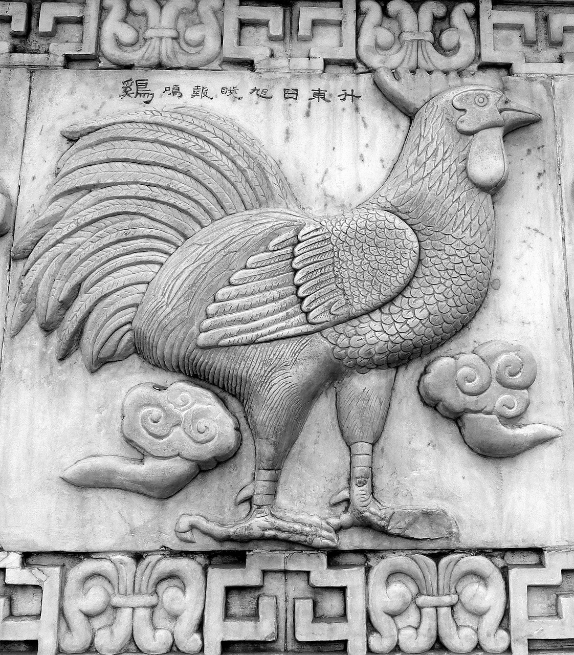 a black and white photo of a rooster on a wall, by Paul Howard Manship, art deco, ancient chinese architecture, highly detailed stonework, very symmetrical body, chinese text