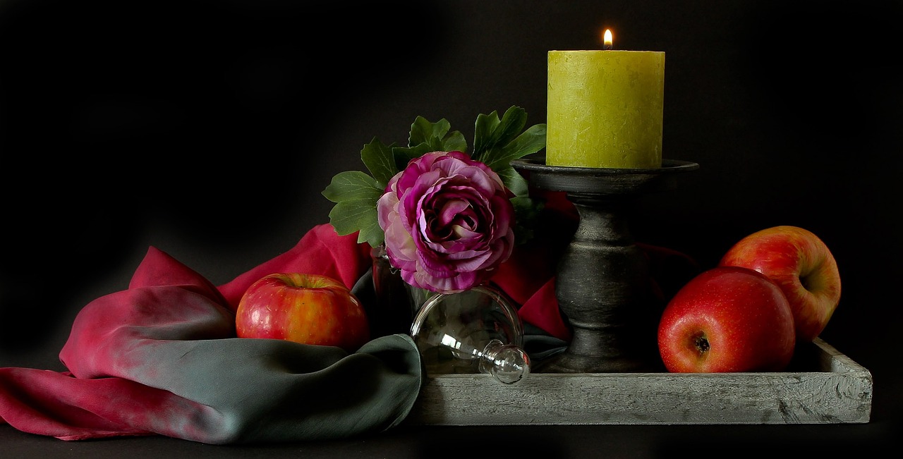 a candle and some apples on a tray, inspired by Allan Ramsay, pexels, romanticism, draped in velvet and flowers, complementary color, looking left, pillar