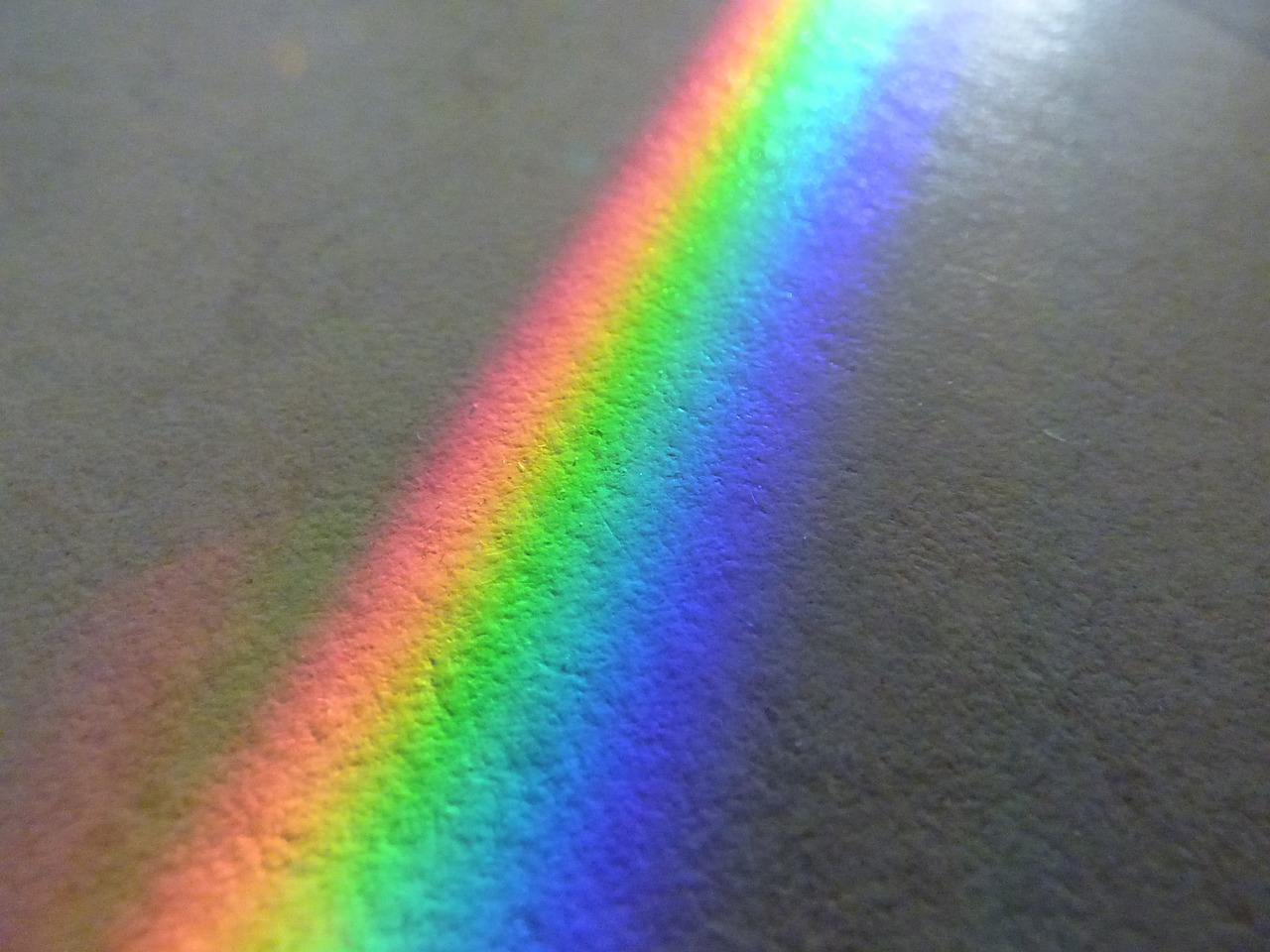 a rainbow shines brightly on the floor of a room, pexels, holography, high resolution macro photo, obama prism, closeup photo, iphone detailed photo