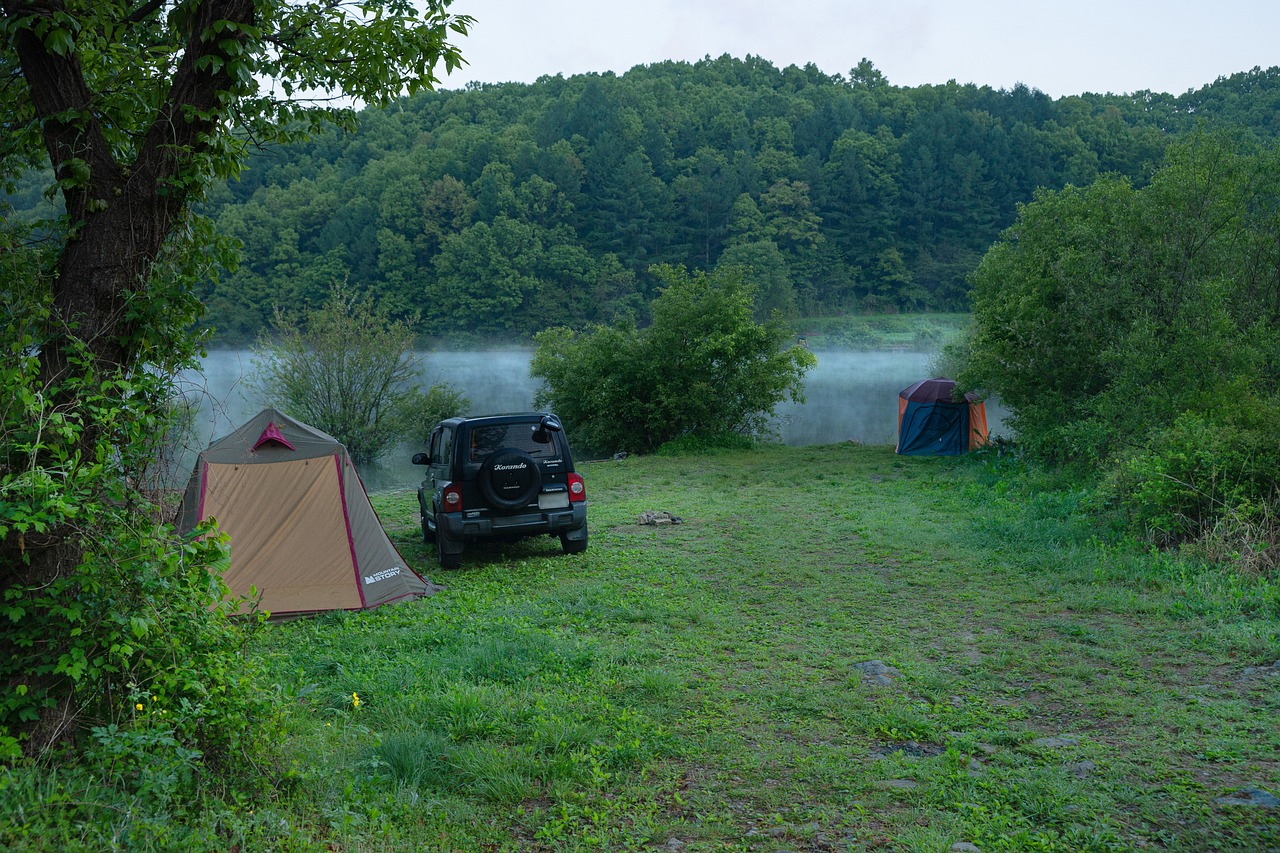 a car parked next to a tent next to a lake, a picture, by Alexander Runciman, misty morning, korean countryside, william penn state forest, very very very beautiful scenery