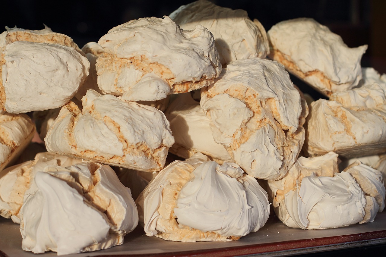 a pile of cookies sitting on top of a table, by Lee Loughridge, pixabay, white rocks made of bone, whipped cream, closeup - view, glazed