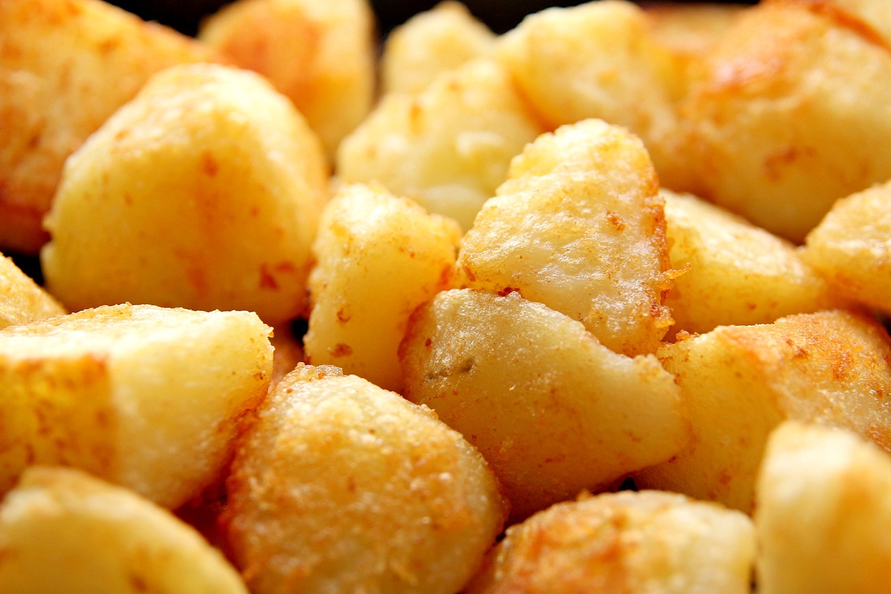 a close up of a pile of fried potatoes, by Ella Guru, high quality product image”