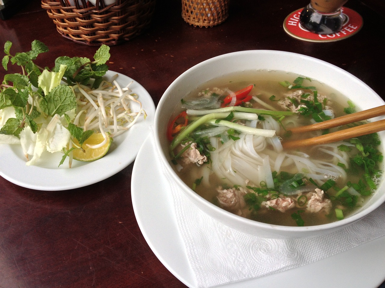 a bowl of soup and a plate of salad on a table, inspired by Tan Ting-pho, cambodia, appetizing, straw, round