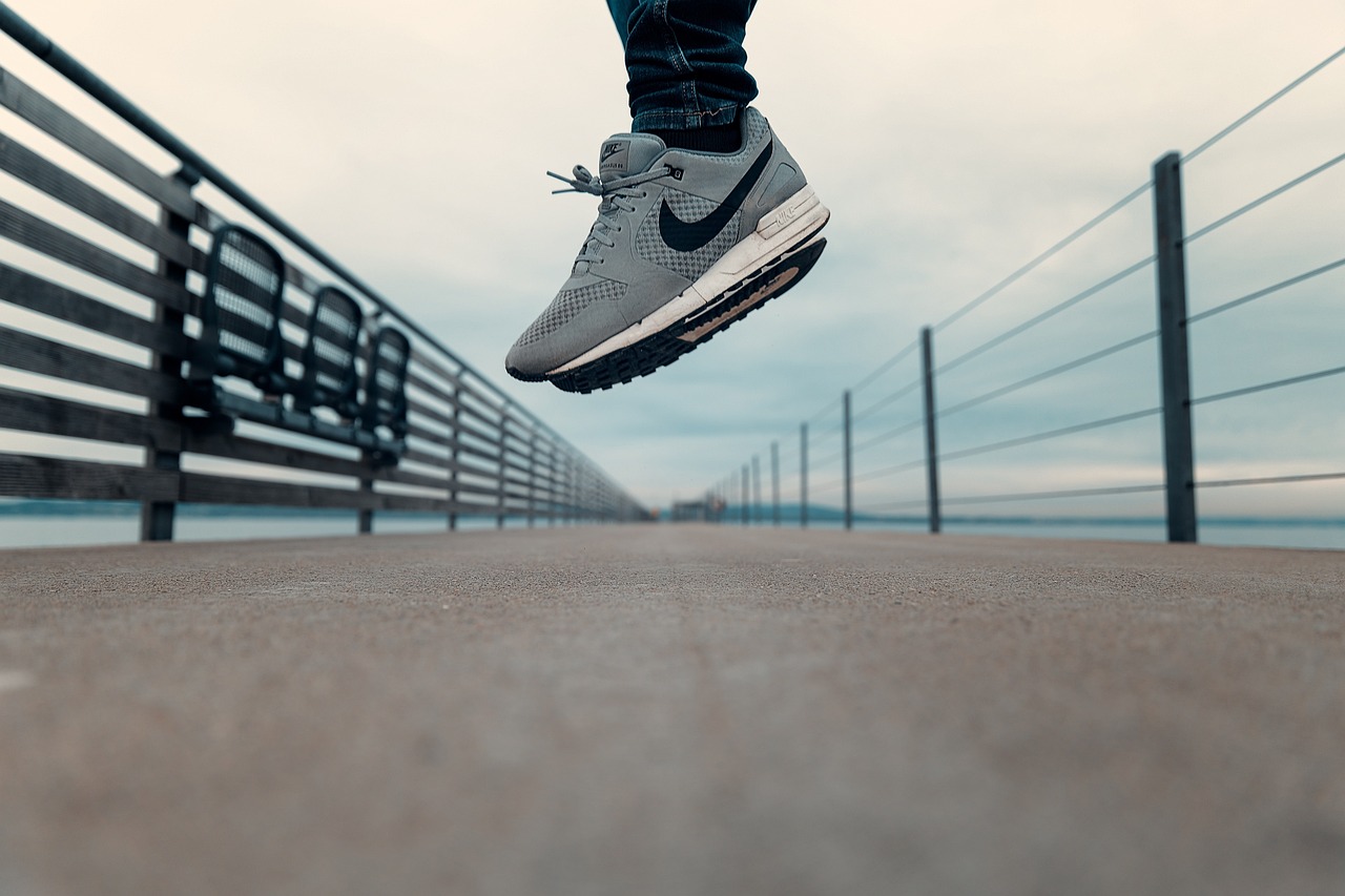 a man flying through the air while riding a skateboard, a stock photo, pexels contest winner, hyperrealism, nike air max, standing on a bridge, highly detailed close up shot, stock photo