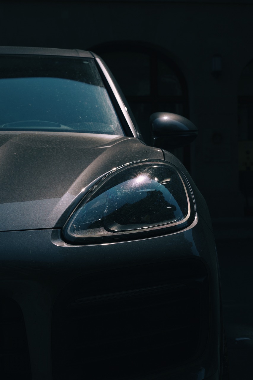 a car parked in front of a parking meter, by Thomas Häfner, pexels contest winner, photorealism, perfectly lit face, porsche, underexposed grey, 2 0 % pearlescent detailing
