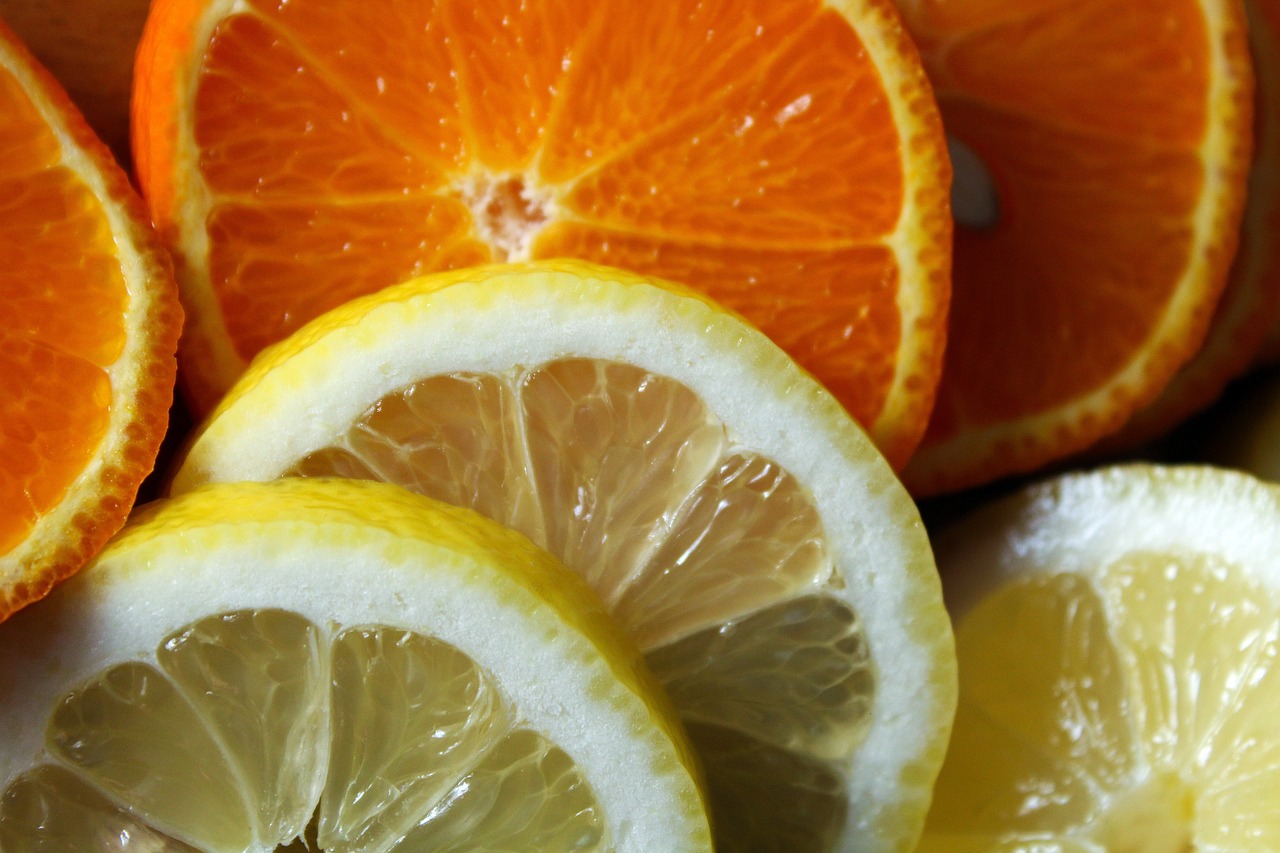 a close up of sliced oranges and lemons, full of colour 8-w 1024, close up shot, warm and joyful atmosphere, high quality product image”