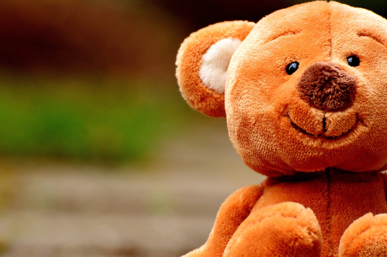a brown teddy bear sitting on the ground, by Jesper Knudsen, wallpaper mobile, sweet smile, fuzzy orange puppet, zoomed in
