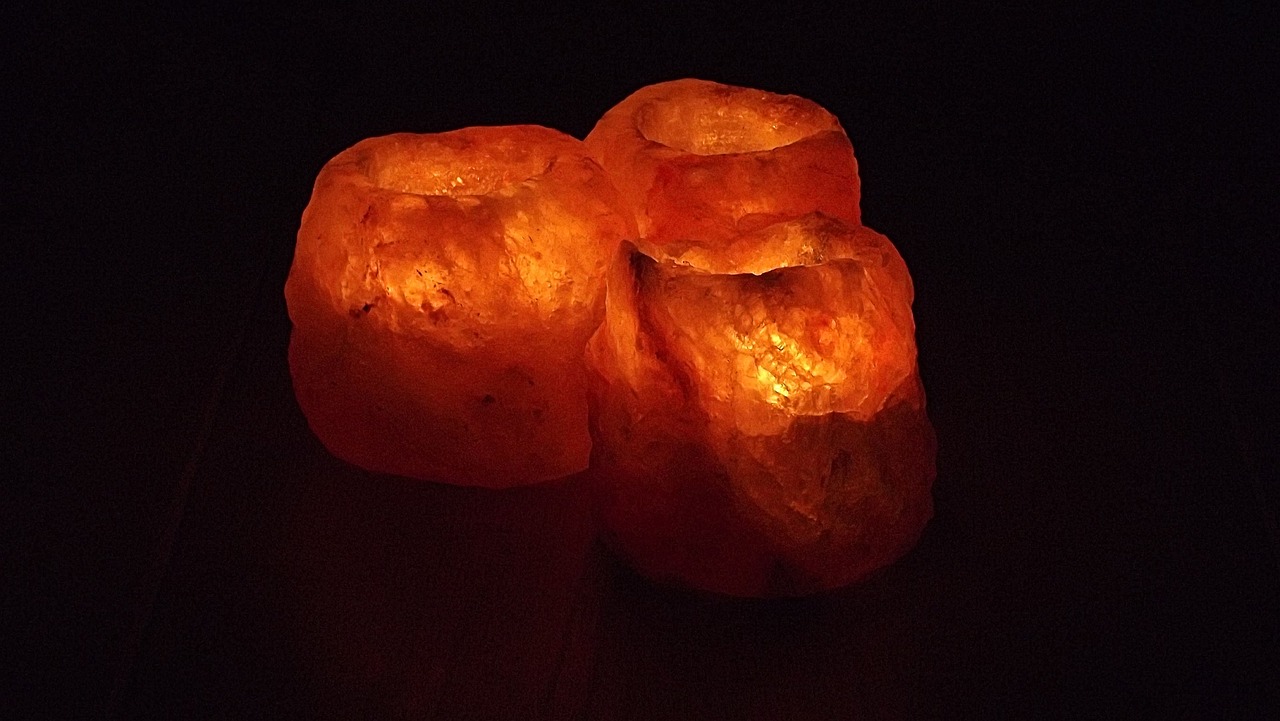 a couple of candles sitting on top of a table, orange minerals, soft volumetric lights, 3 - piece, ( ( emma lindstrom ) )