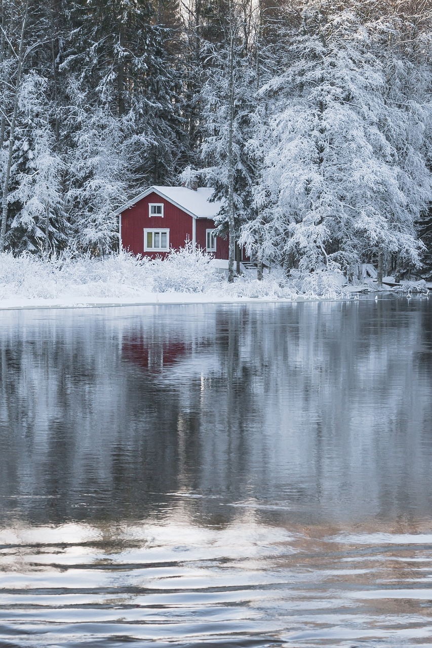 a red house sitting on top of a snow covered lake, a picture, inspired by Eero Järnefelt, shutterstock, full frame shot, build in a forest near of a lake, high res photo, detailed reflections