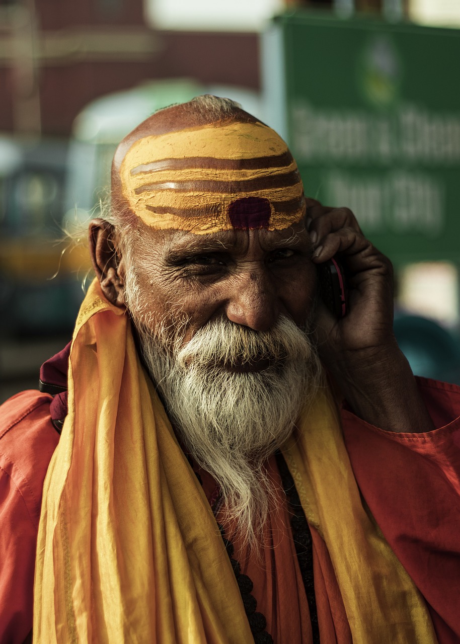 a close up of a person talking on a cell phone, by Matthias Weischer, pexels contest winner, wise old indian guru, avatar image, cute photo, outher worldly colours