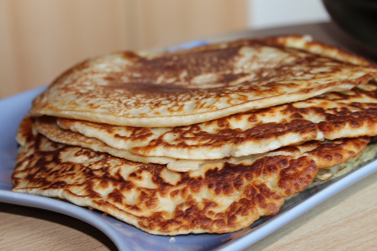 a stack of pancakes sitting on top of a blue plate, by Alice Mason, flickr, hurufiyya, turkey, middle close up shot, sables crossed in background, fully covered