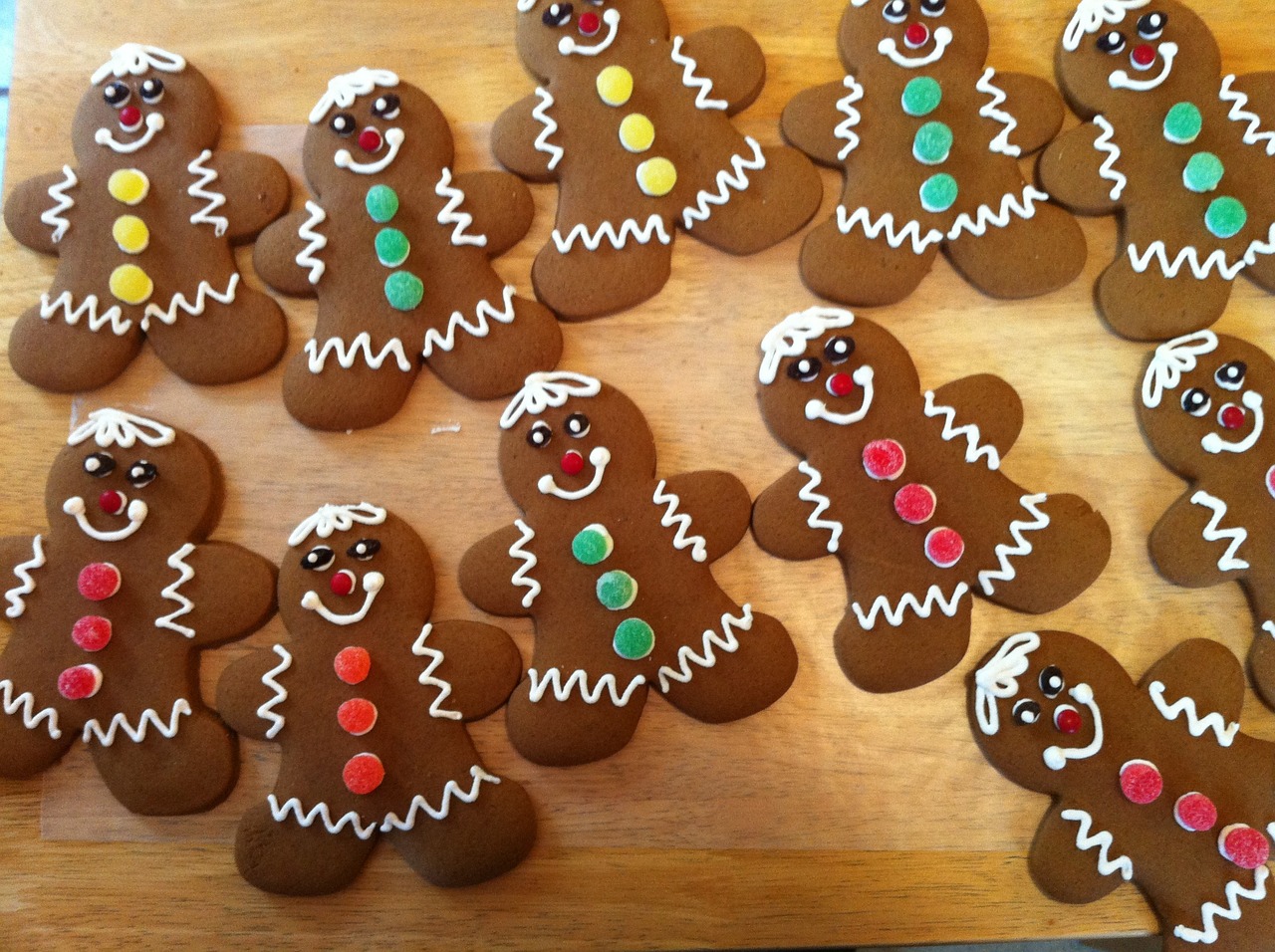 a wooden cutting board topped with lots of decorated gingerbreads, by John Henderson, eyes!, 3 pm, cute boys, recipe