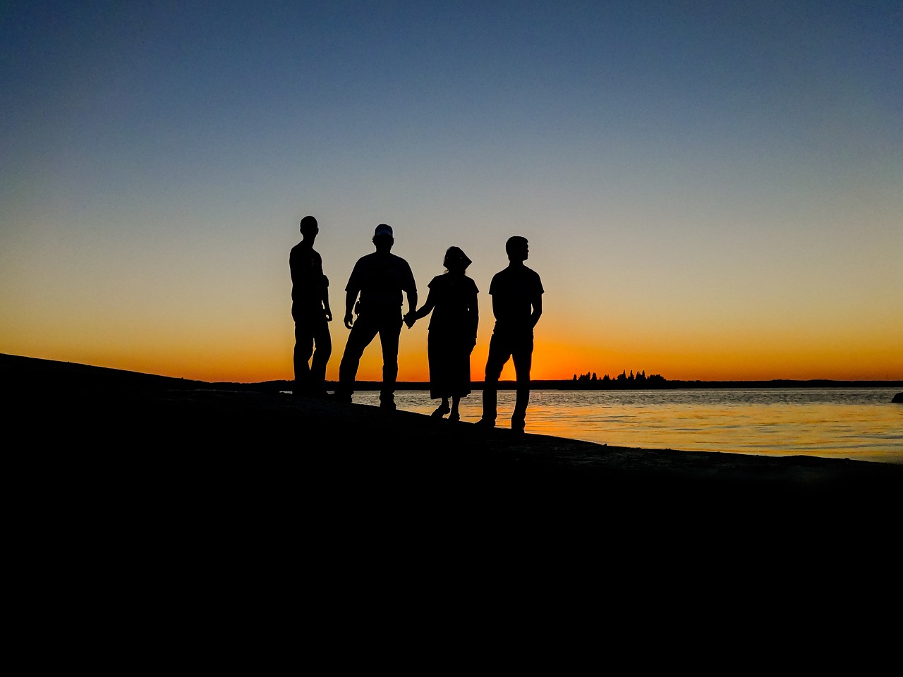 a group of people standing on top of a beach, a picture, by Matthew D. Wilson, backlight photo sample, manly, lakeside, band