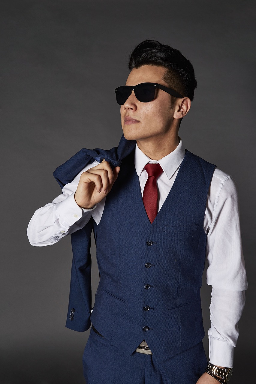 a man wearing a blue suit and a red tie, inspired by Yasutomo Oka, bauhaus, fashion model in sunglasses, wearing suit vest, professional product photo, woo kim