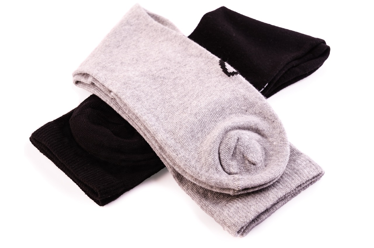 three pairs of socks sitting on top of each other, by Thomas Häfner, shutterstock, black and silver, cutout, highly_detailded, double layer fold over hem