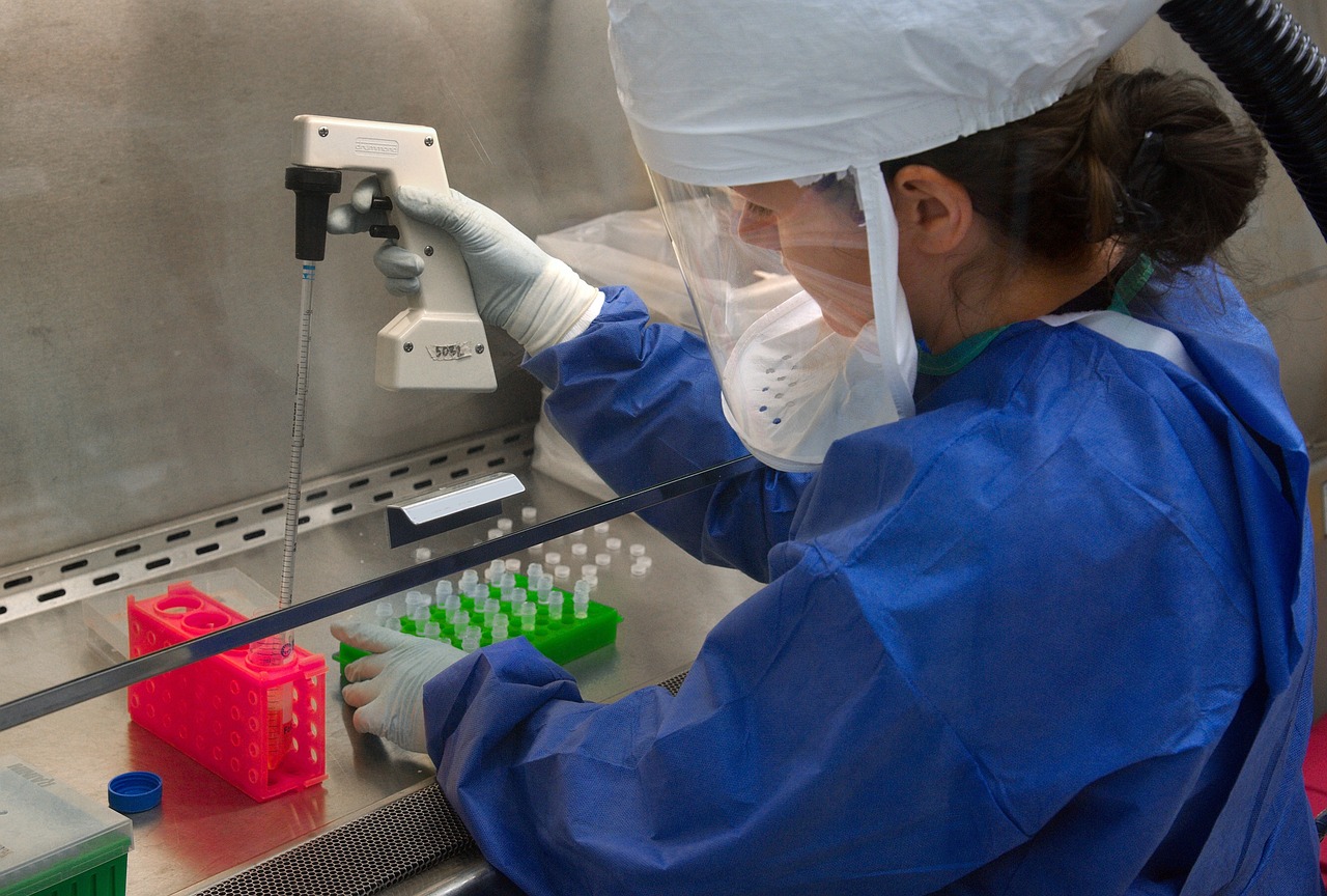 a woman in a lab coat working on a machine, flickr, rna bioweapon, sao paulo, hooded, high res photo