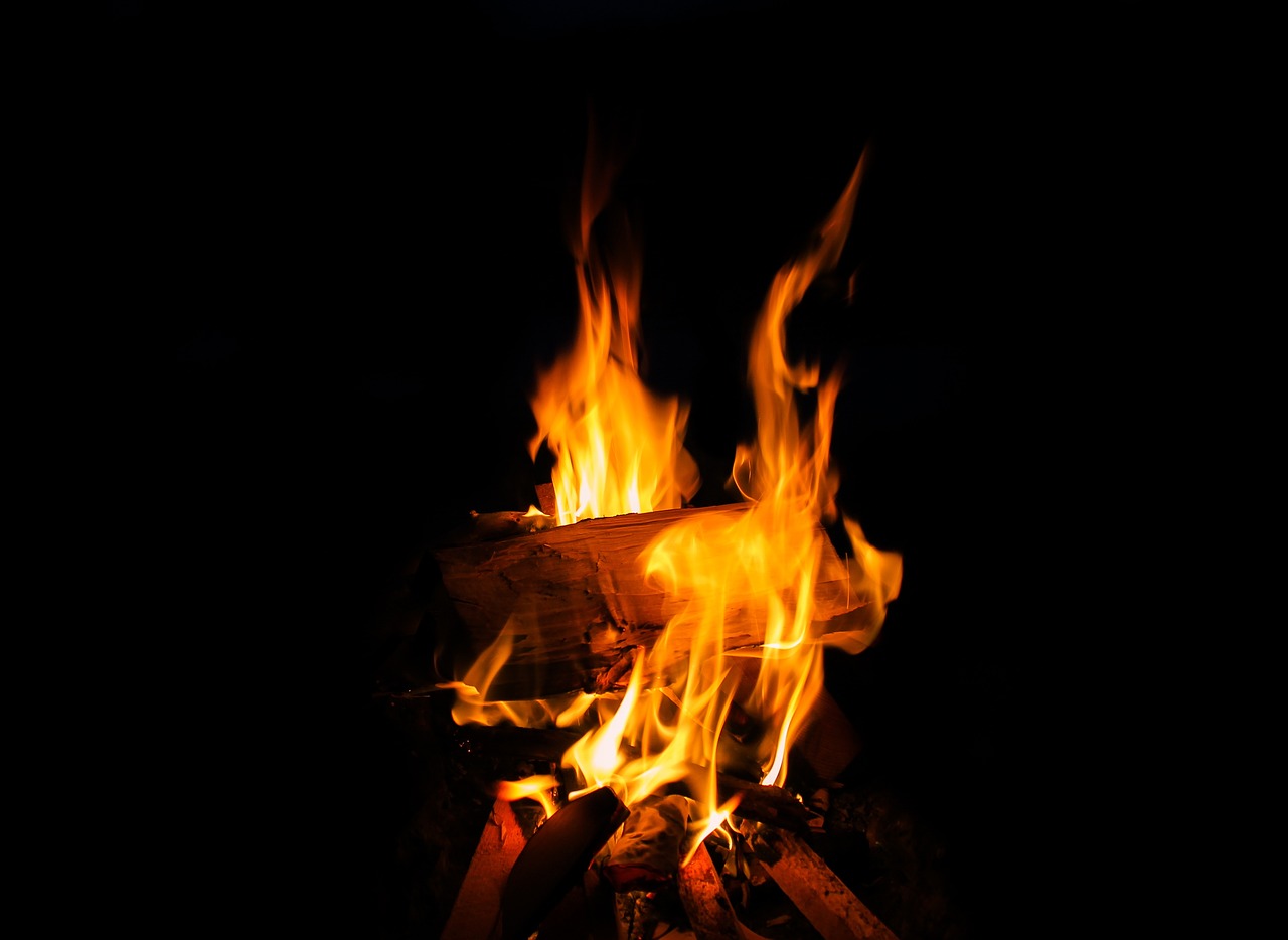 a close up of a fire in the dark, a picture, shutterstock, outdoor photo, a wooden, set photo, stock photo