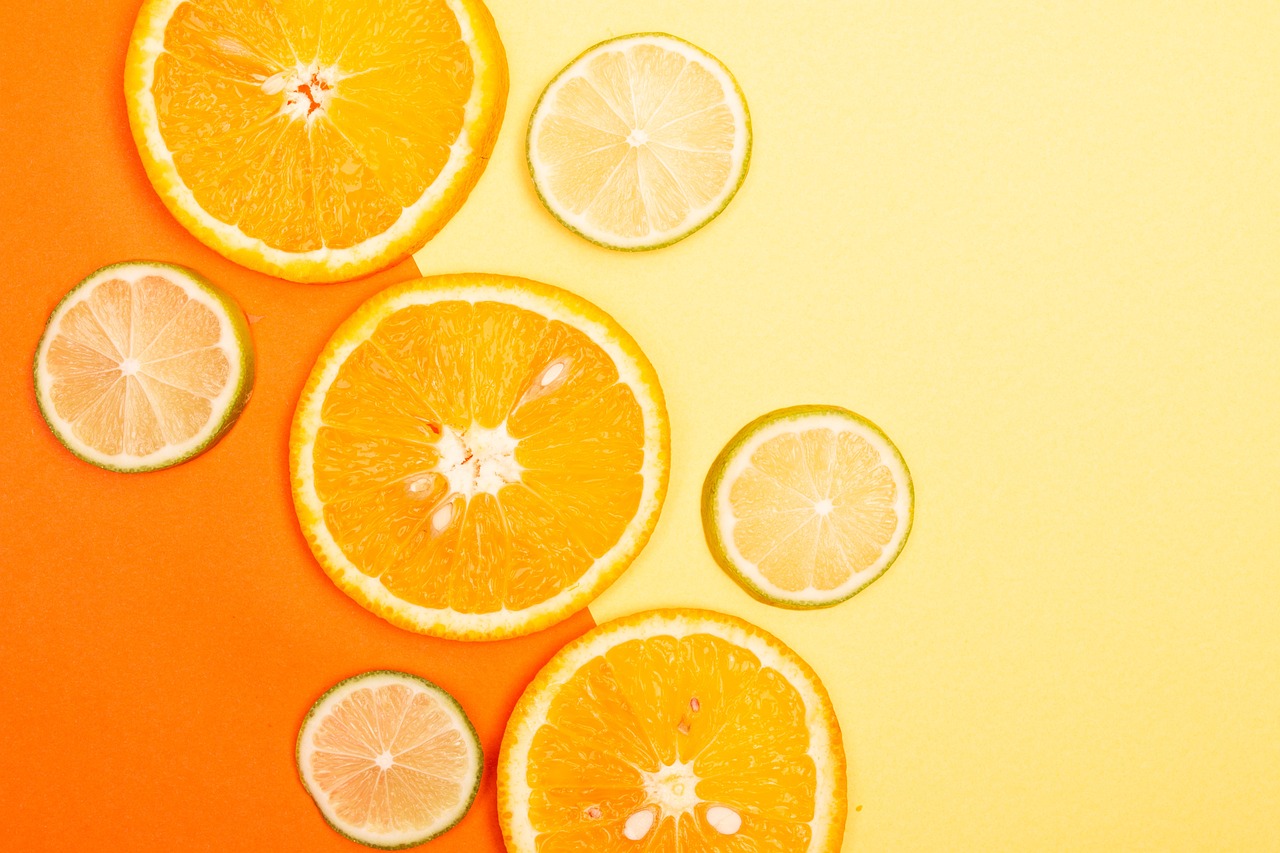 a group of sliced oranges sitting on top of a table, a screenshot, by Anna Haifisch, trending on unsplash, minimalism, colorful backdrop, citrinitas, avatar image, vibrant light color scheme