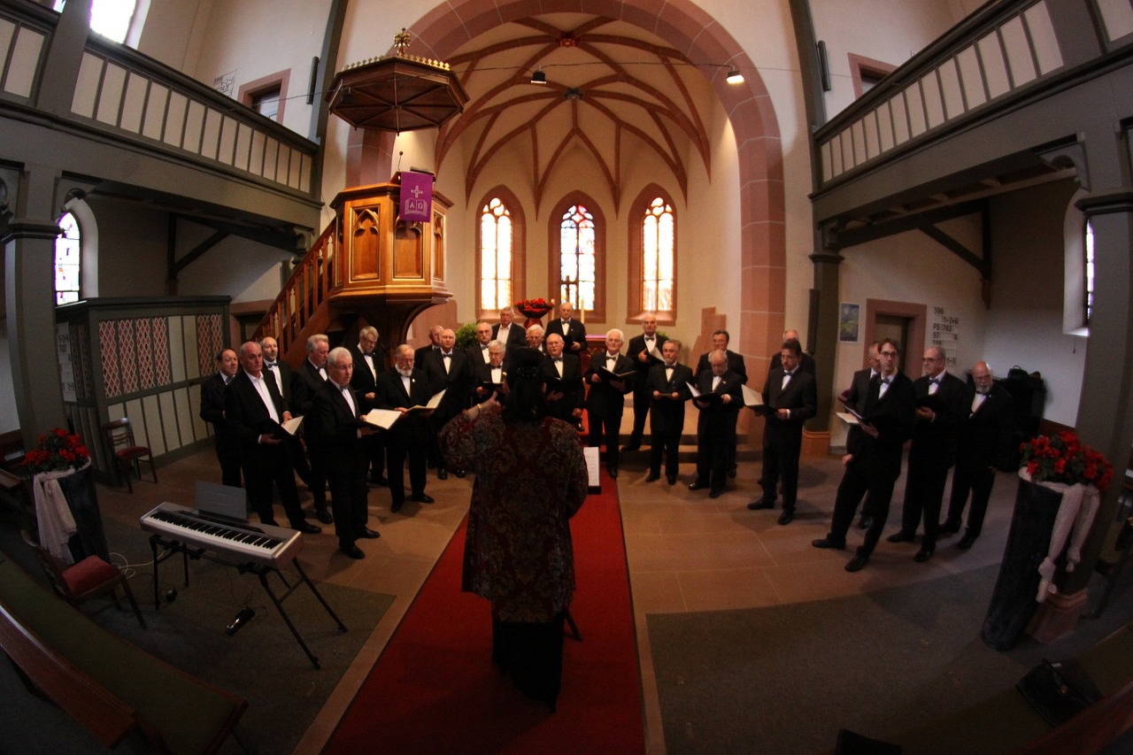 a group of men standing next to each other in a church, a photo, by Caroline Mytinger, flickr, singing, germany. wide shot, recital, overlooking