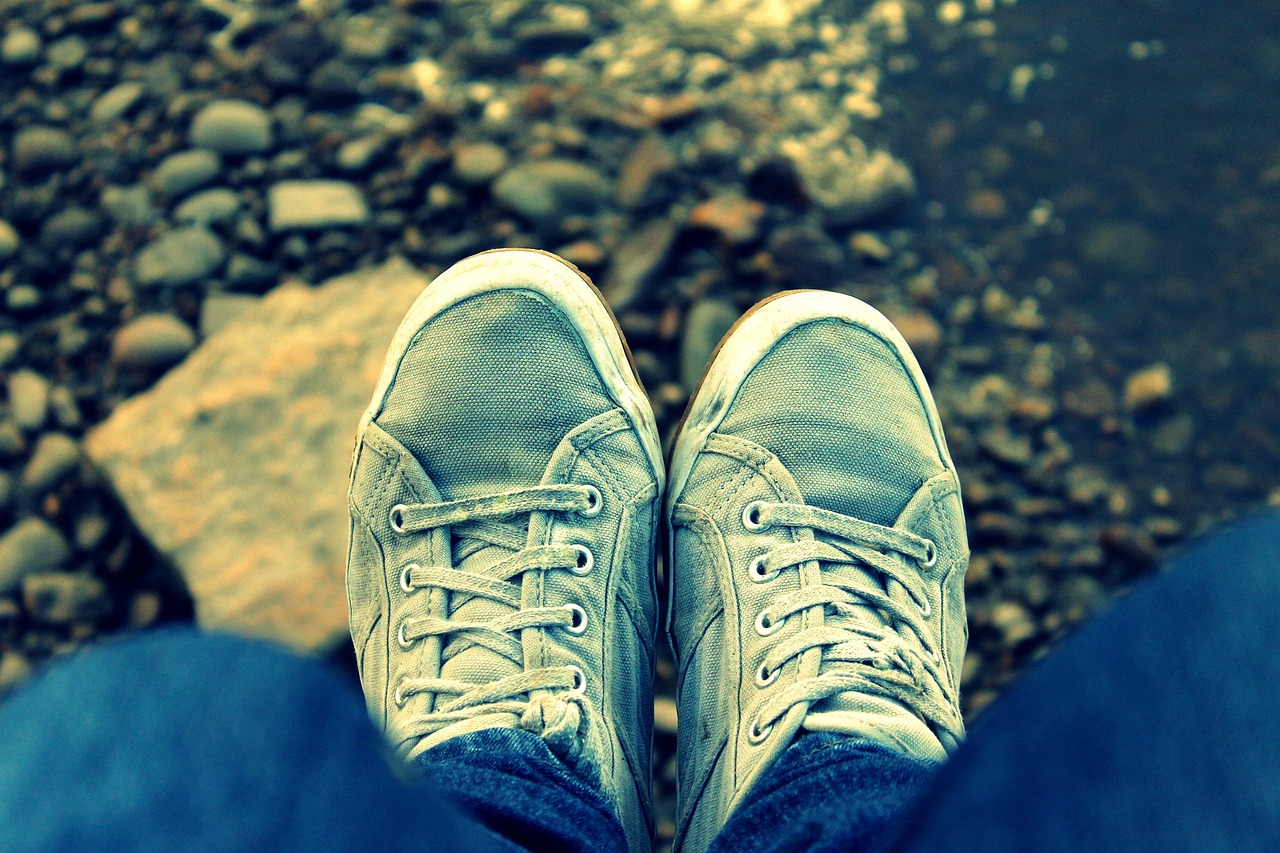 a pair of shoes sitting on top of a person's feet, a picture, realism, blue and grey tones, faded memories, wallpaper mobile, 400 steps