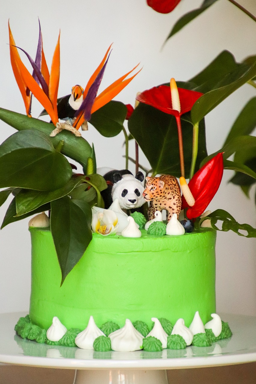 a green cake sitting on top of a white plate, inspired by Max Buri, wild jungle, filled with plants and habitats, panda, tropic plants and flowers