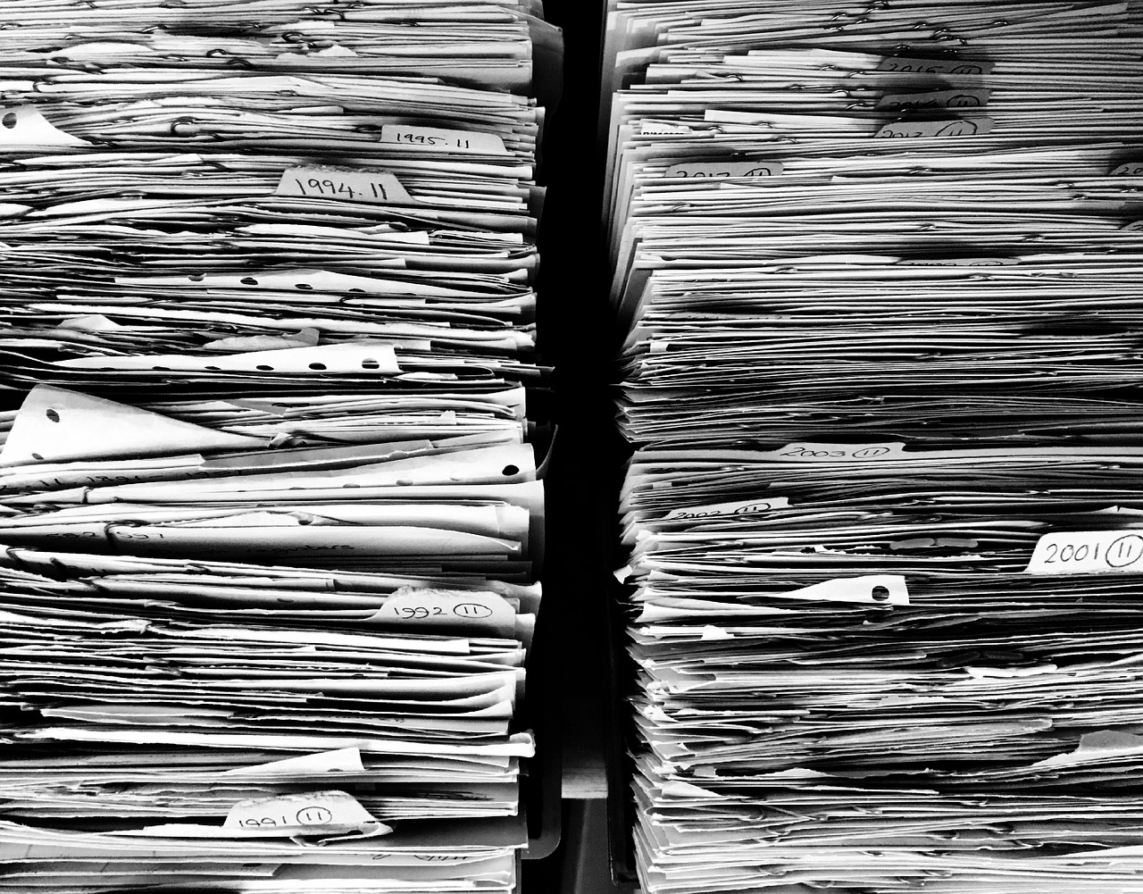 a bunch of papers stacked on top of each other, a photocopy, pexels, grainy tri-x pushed to 3200, shot on leica sl2, taken on iphone 14 pro, take control of your data