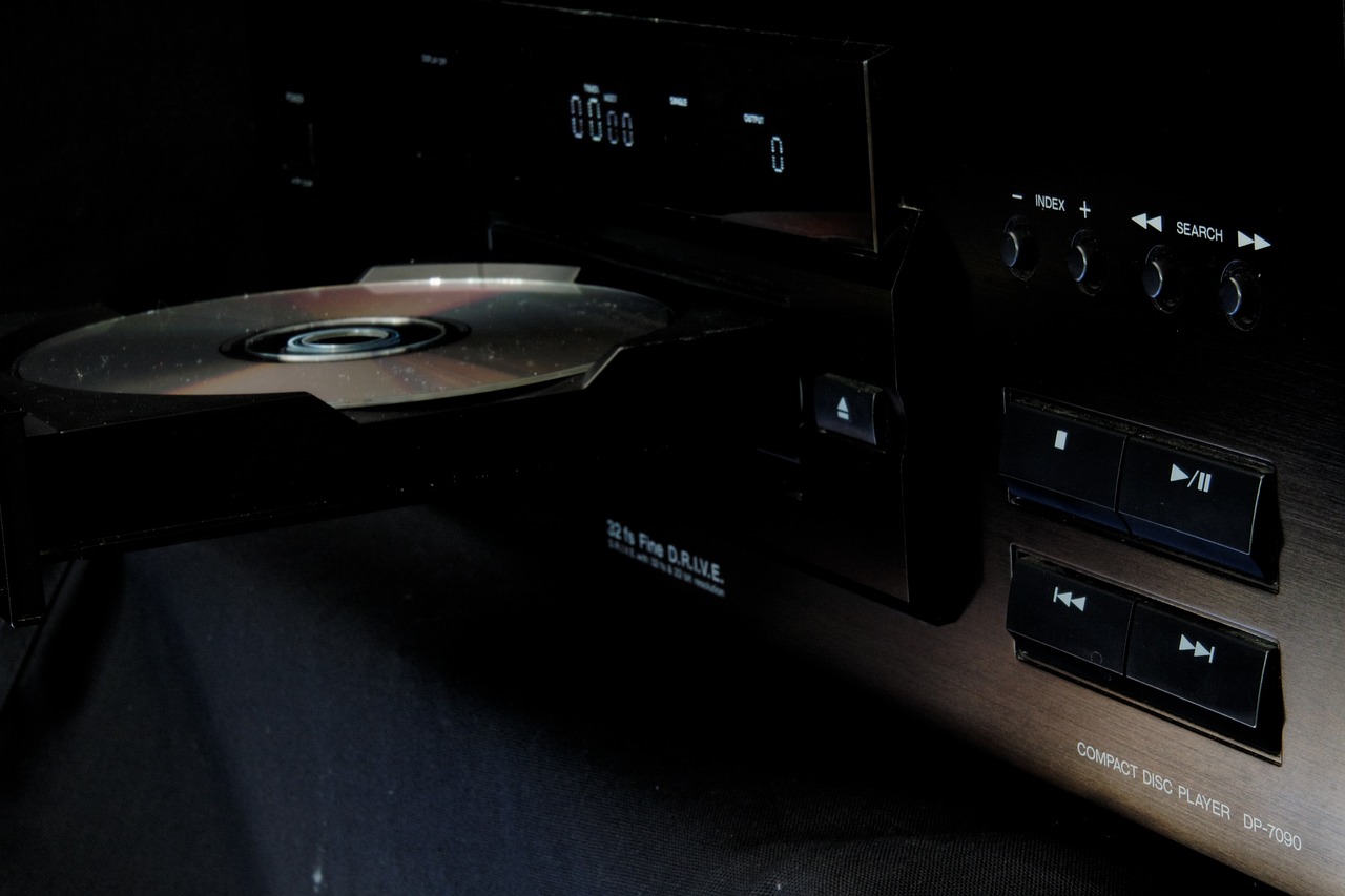 a close up of a cd player in the dark, an album cover, by Andrei Kolkoutine, unsplash, panorama shot, bluray, sennheiser, on display