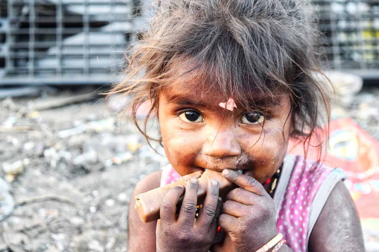 a close up of a child eating something, inspired by Steve McCurry, beautiful lady, slums, photo taken in 2 0 2 0, small