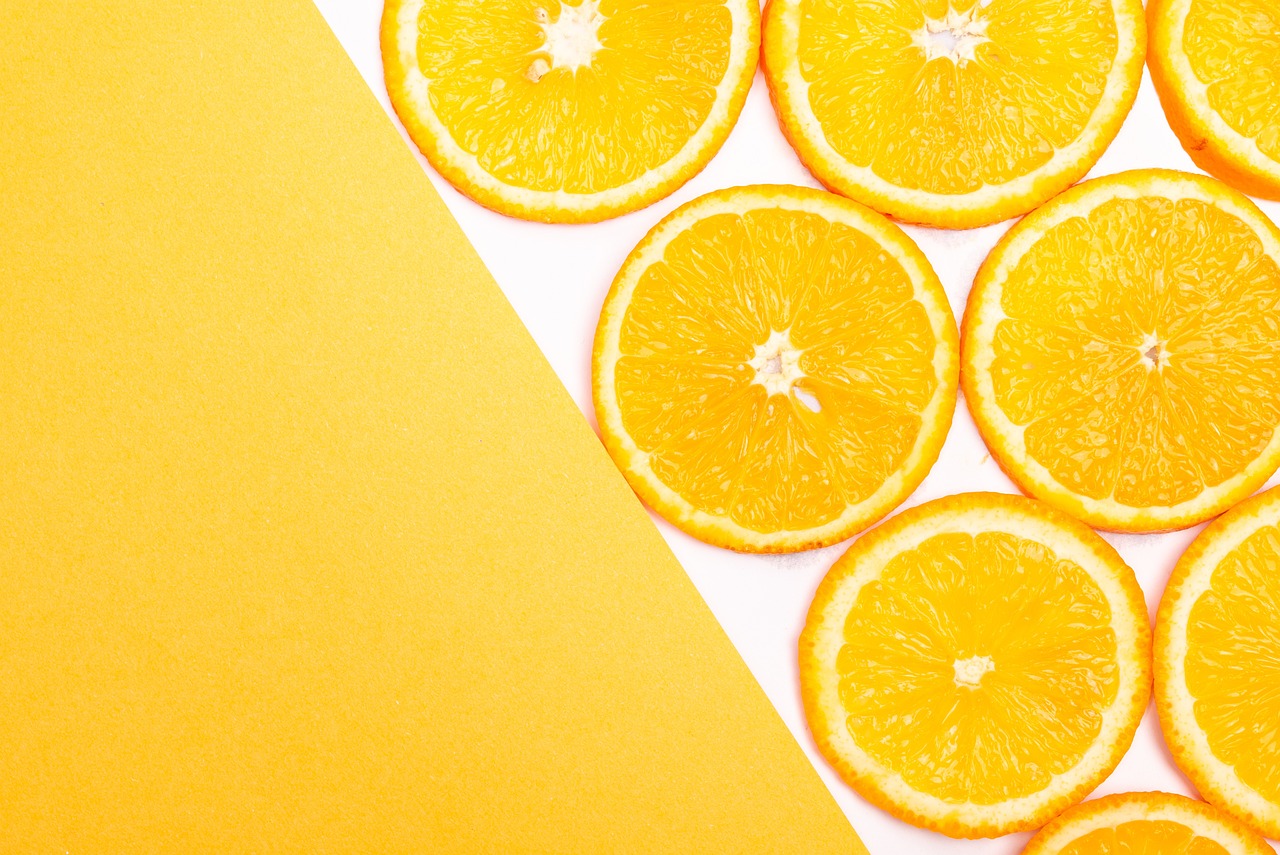 a group of orange slices sitting on top of a piece of paper, a stock photo, postminimalism, yellow color scheme, high quality product image”