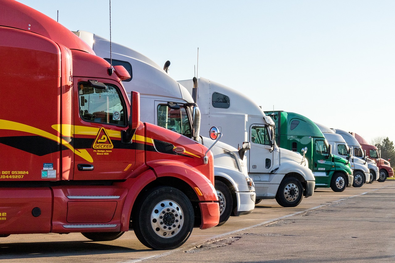 a row of semi trucks parked in a parking lot, renaissance, various colors, high res photo, in profile, ergonomic