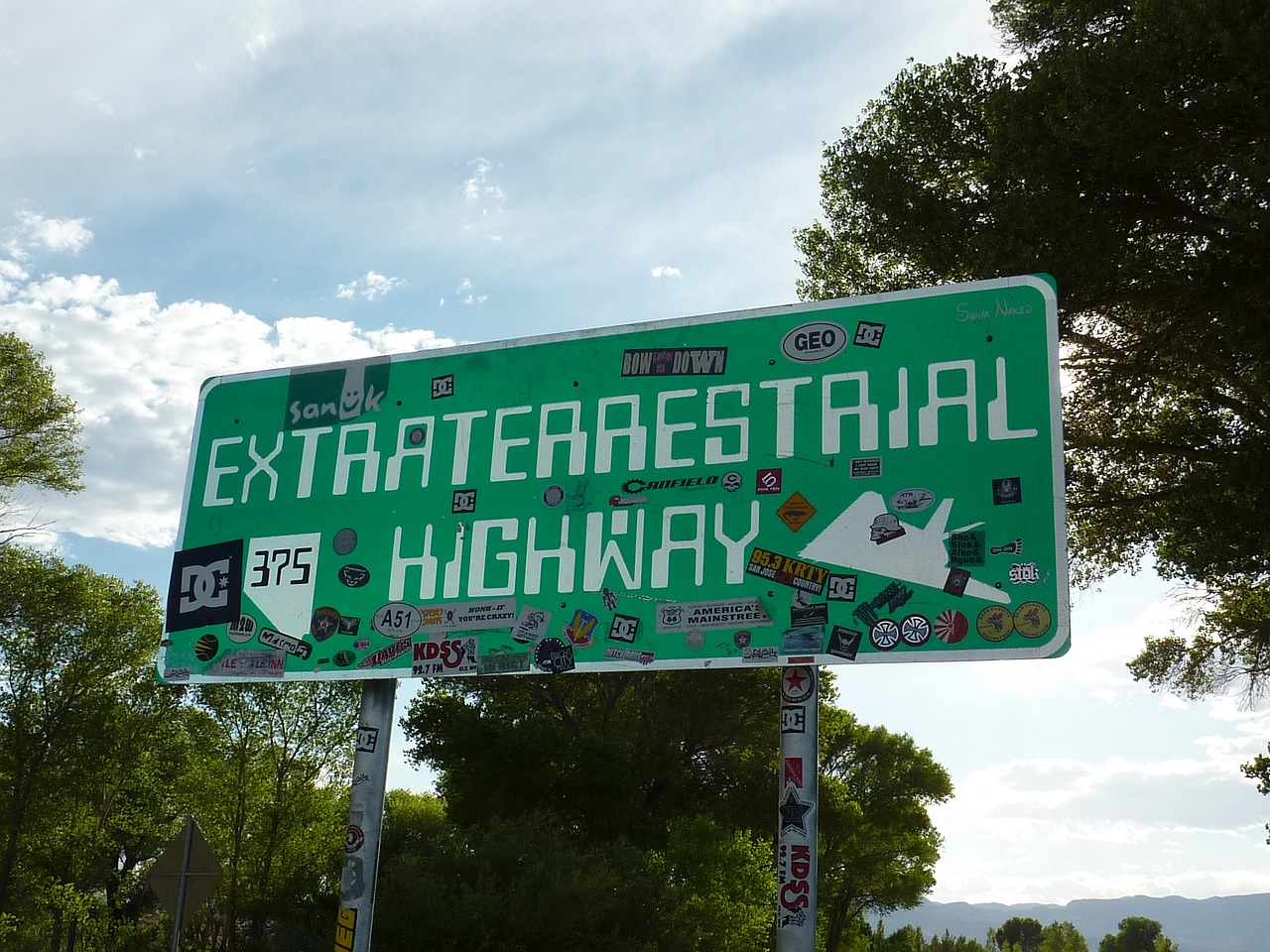 a green street sign sitting on the side of a road, by Dennis Ashbaugh, extraterrestrial paradise, extreme panoramic, highway 5 0, rafeal albuquerque