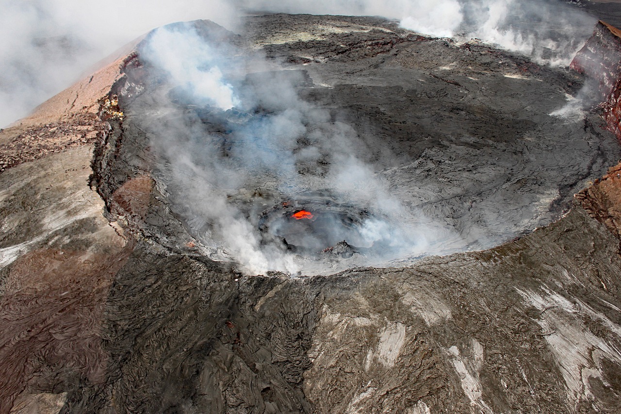 there is a small red object in the middle of the crater, a photo, pexels, hurufiyya, big island, july 2 0 1 1, 1 male, aerial