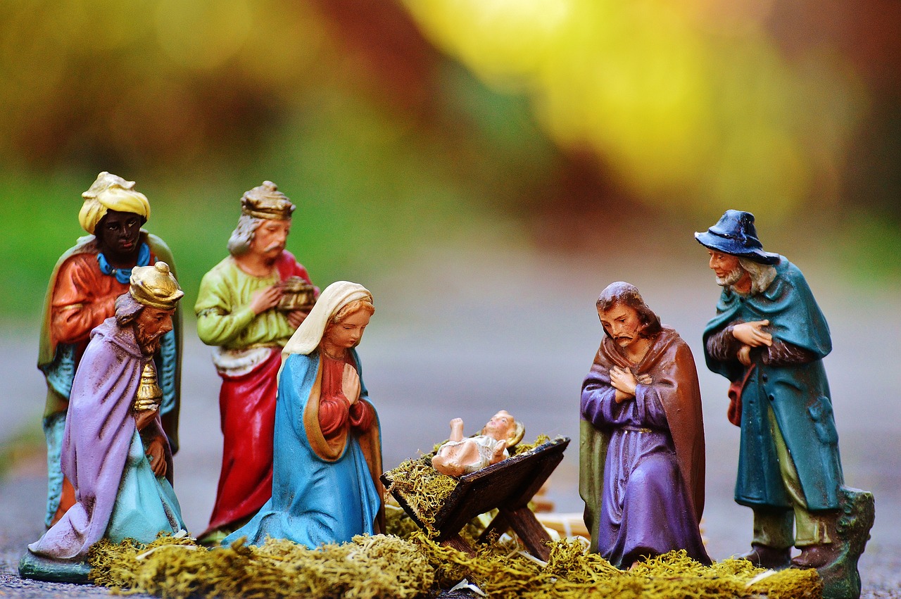 a group of figurines sitting on top of a pile of hay, a tilt shift photo, shutterstock, with infant jesus, beautiful wallpaper, colourful, bench