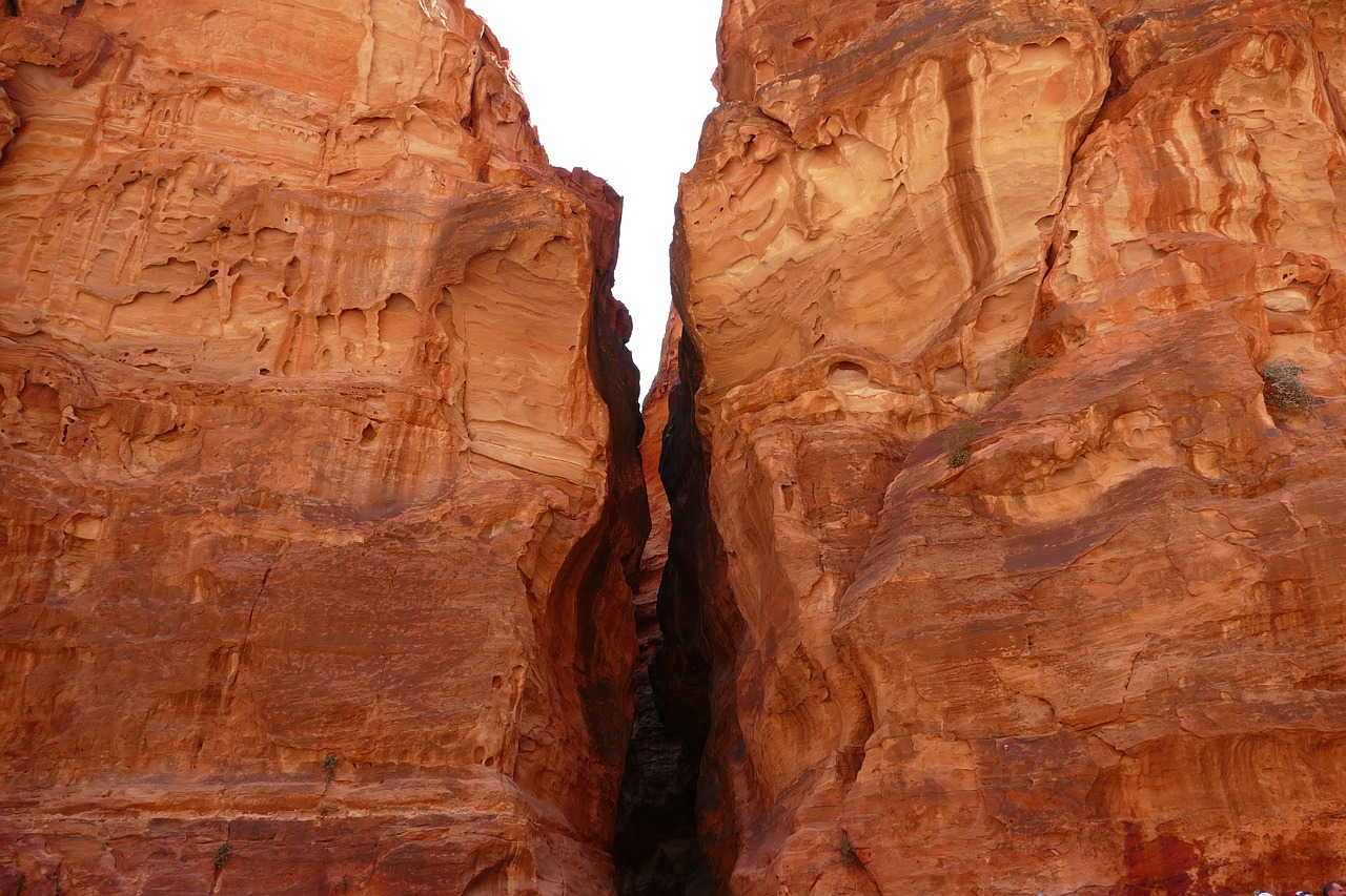 a group of people riding horses through a canyon, a photo, by Erwin Bowien, shutterstock, large cracks, wadi rum, ultrafine detail ”, holes